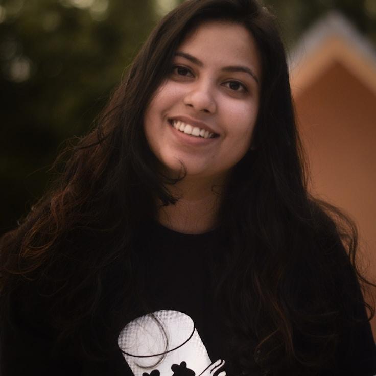 Kaveri Mehta, Lead Design Curator at Window Linen Field, reviewing corporate floral arrangements